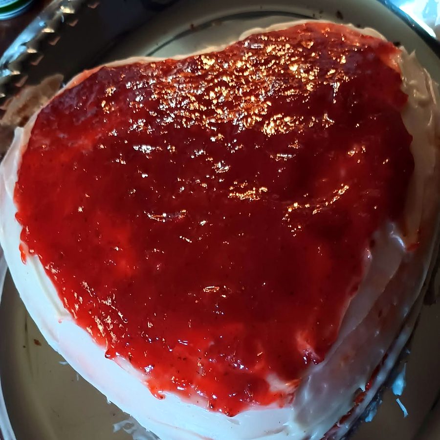 Heart-shaped cake with strawberry topping by Joyeful Treats