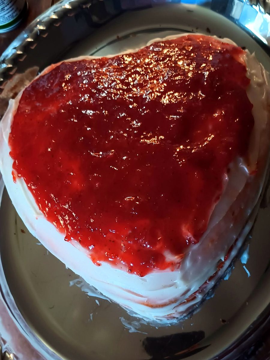 Heart-shaped cake with strawberry topping by Joyeful Treats