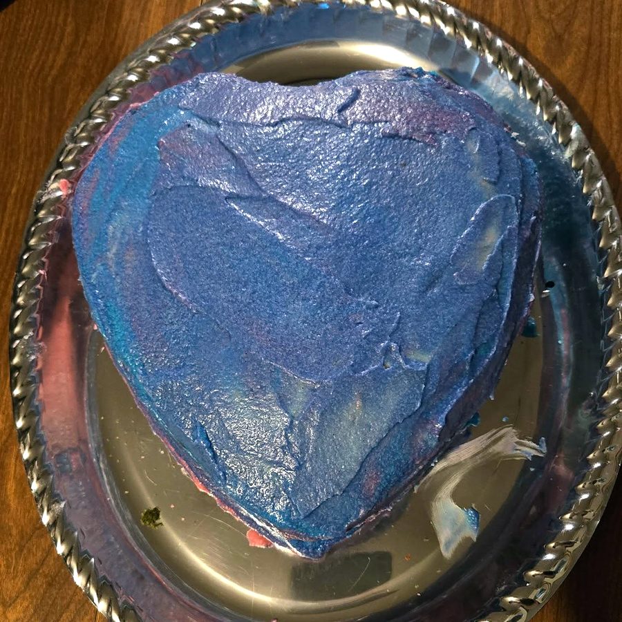Heart-shaped cake with blue frosting by Joyeful Treats
