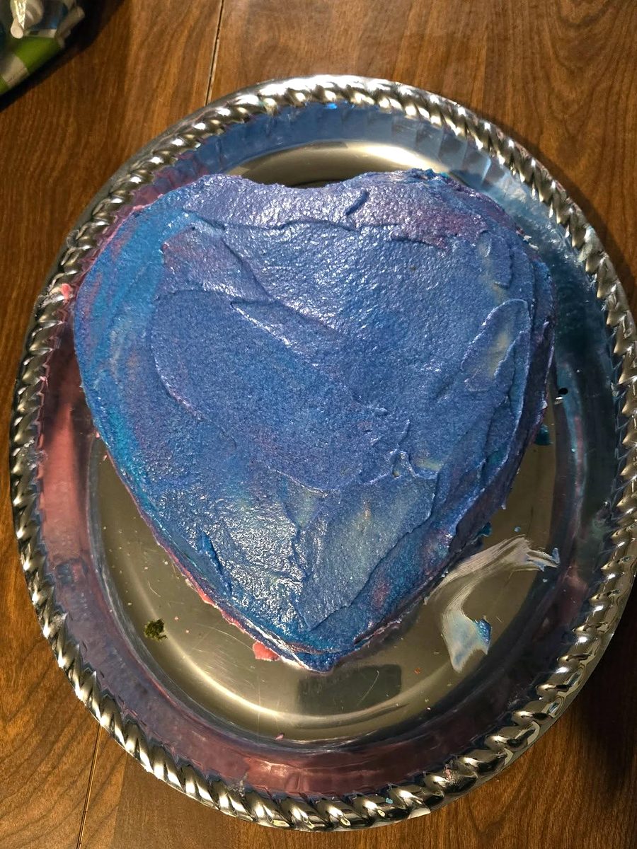 Heart-shaped cake with blue frosting by Joyeful Treats